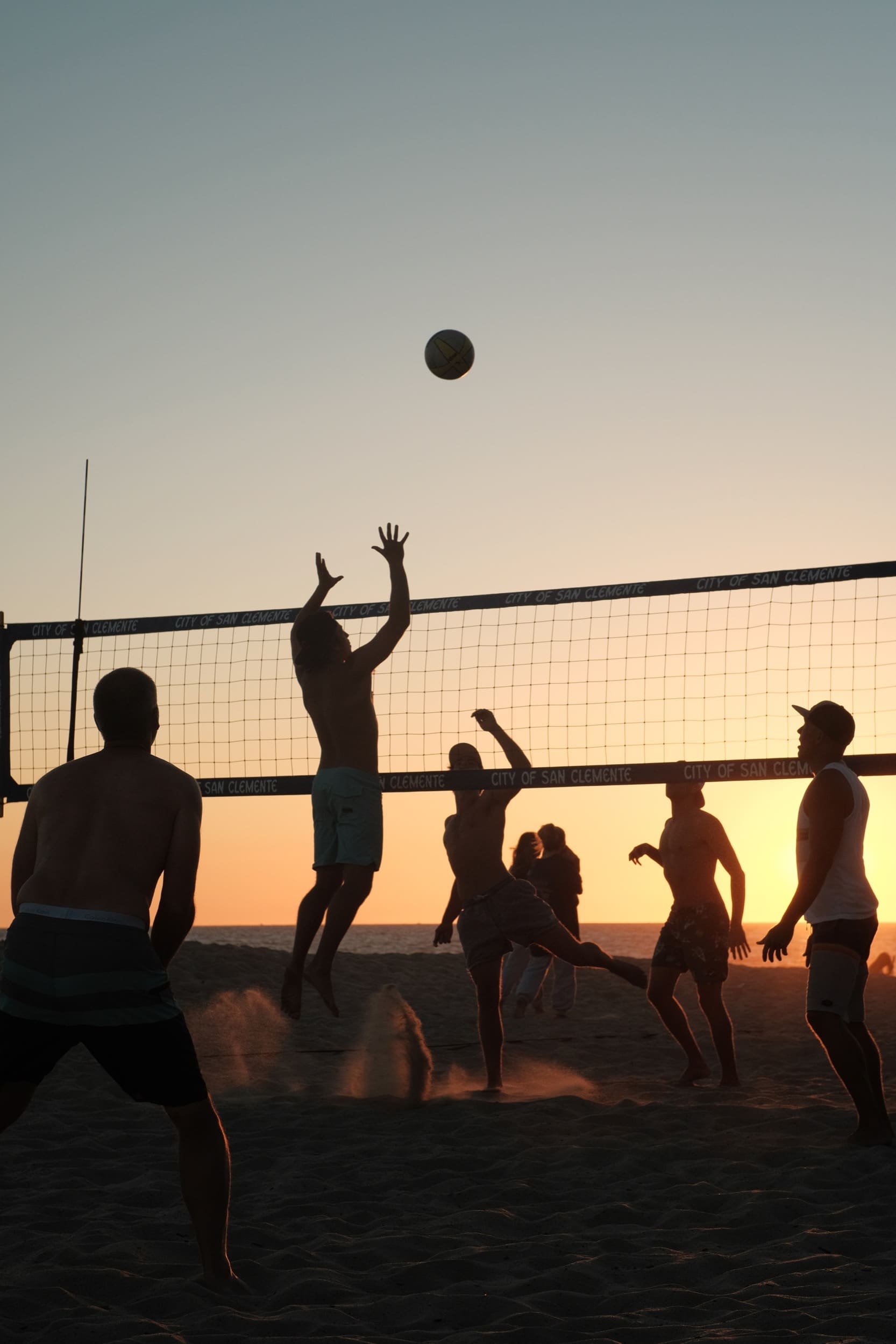 Sports photography, dudes playing volleyball.