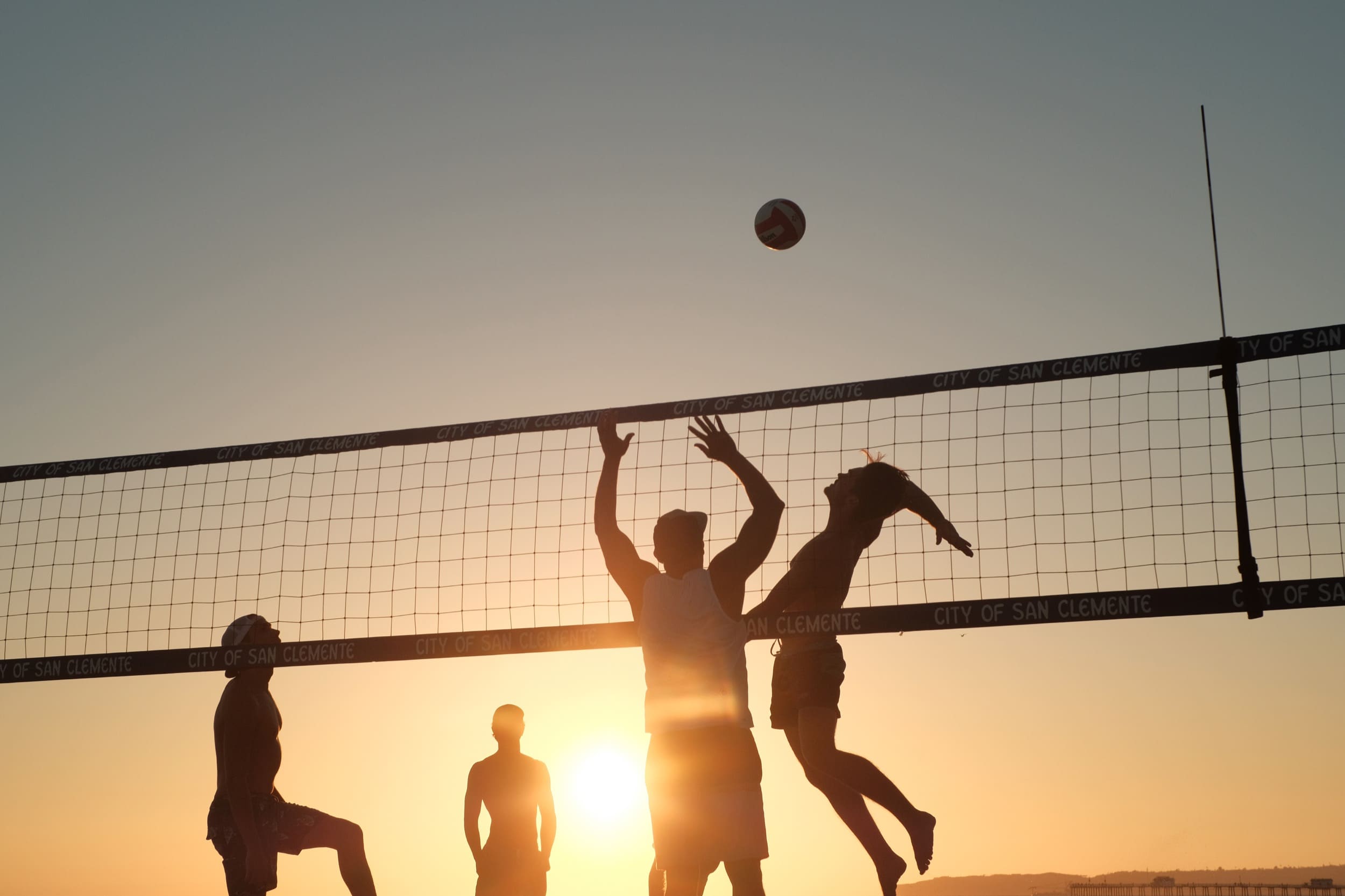 Sports photography, dudes playing volleyball.