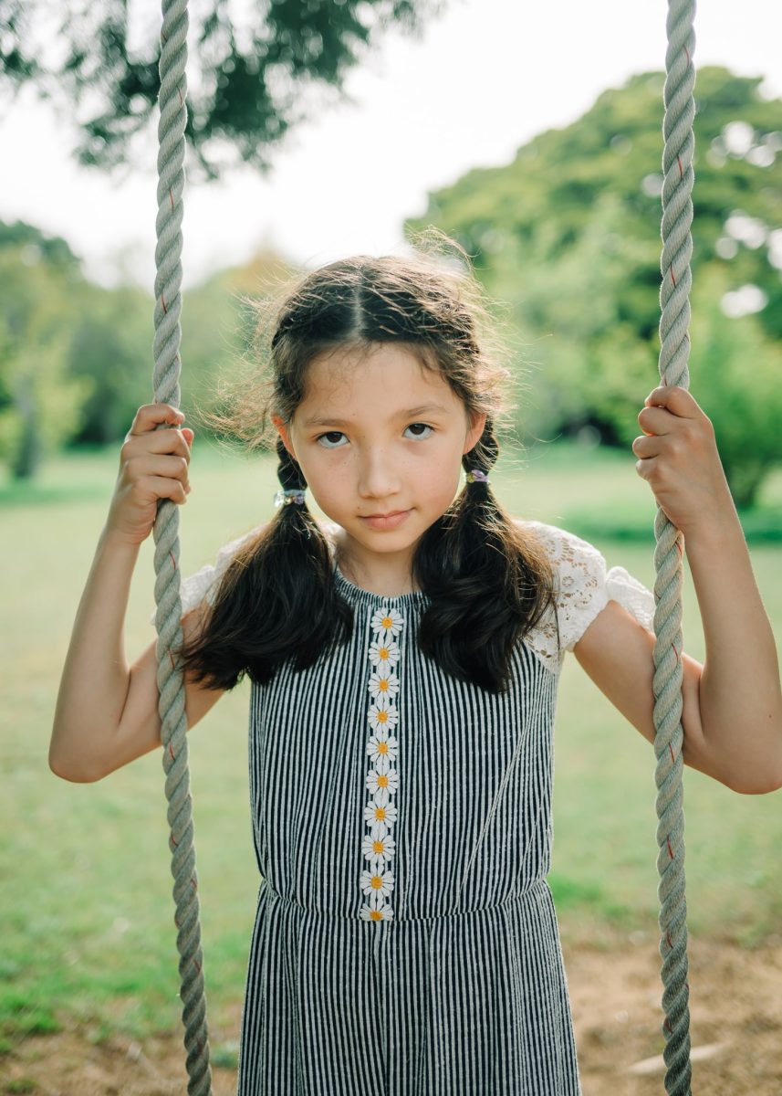 Girl stands on swing