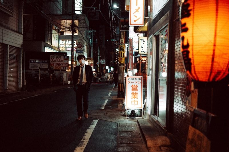 Back alley next to a orange lantern in Japan.