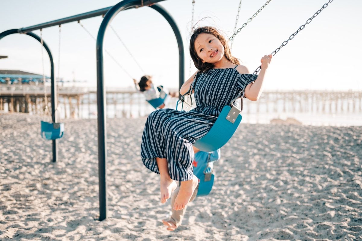 Happy girl on a swing in San Clemente.