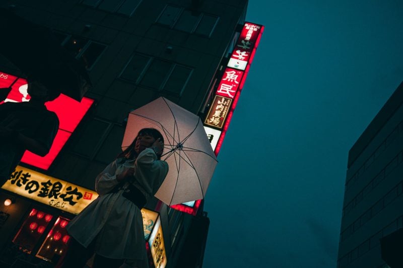 Hakata Japan Street Photo of woman holding umbrella in the rain.
