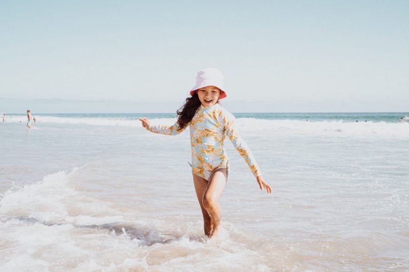 Lifestyle photo of little girl posing at the beach